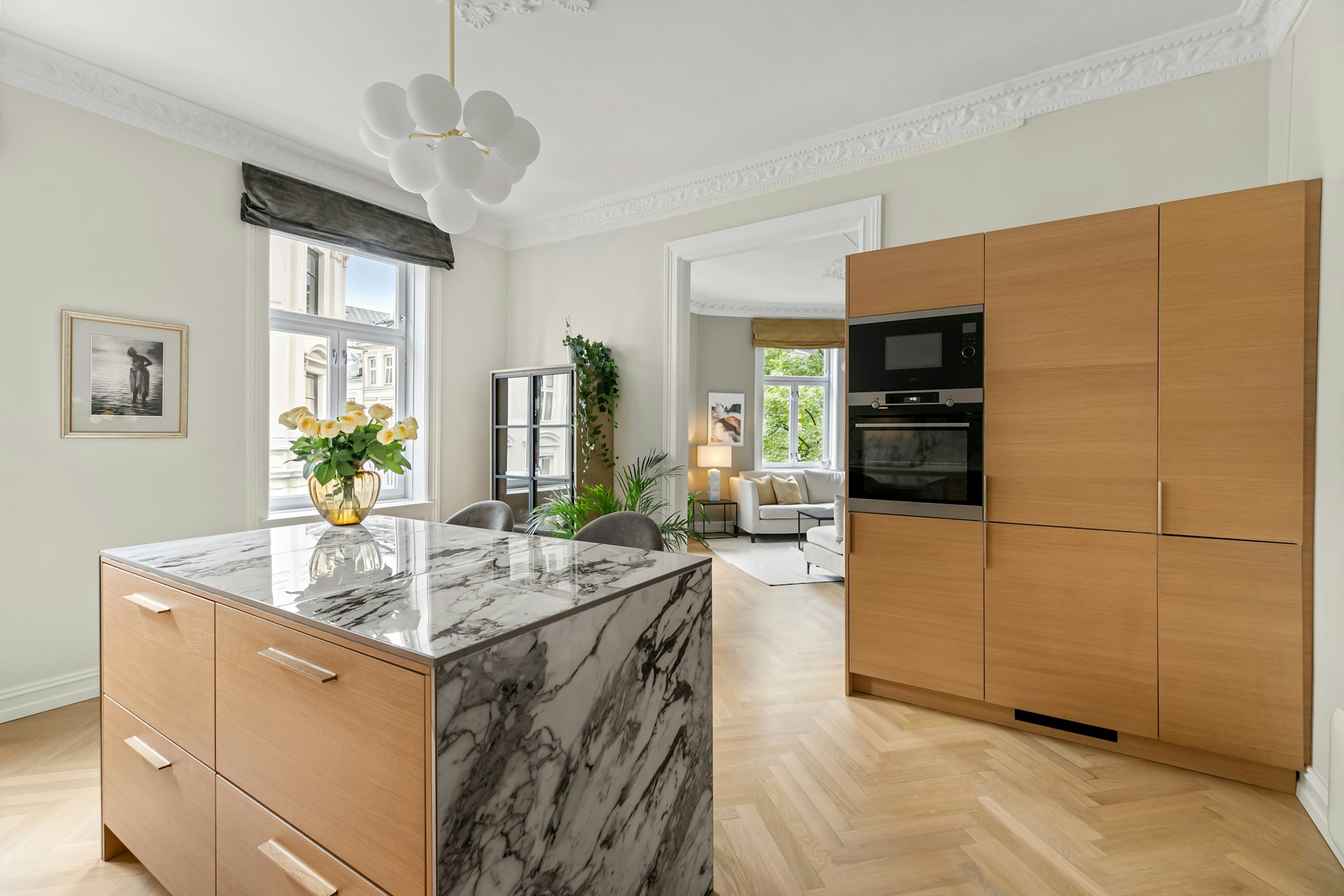 Airy kitchen with oak cabinetry and marble surfaces